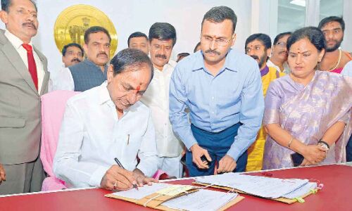 On his first day in his new chamber, CM KCR signs six files.