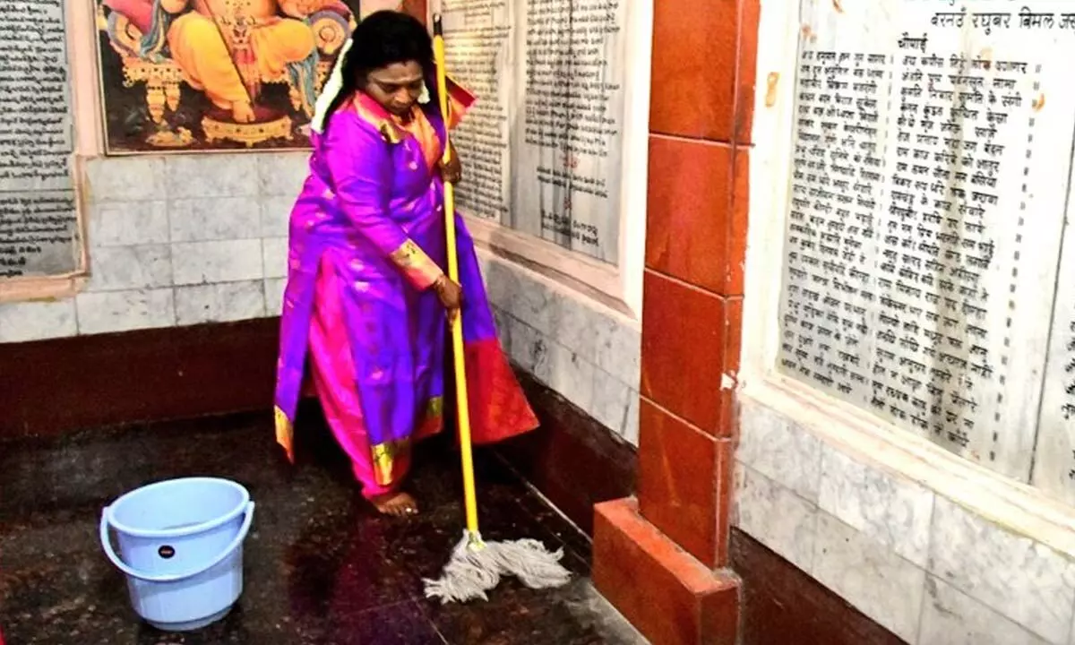 Dr Tamilisai of Hyderabad actively participates in temple cleaning with a broom