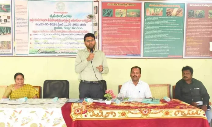 DC BM Santhosh joins farmers in an awareness program.