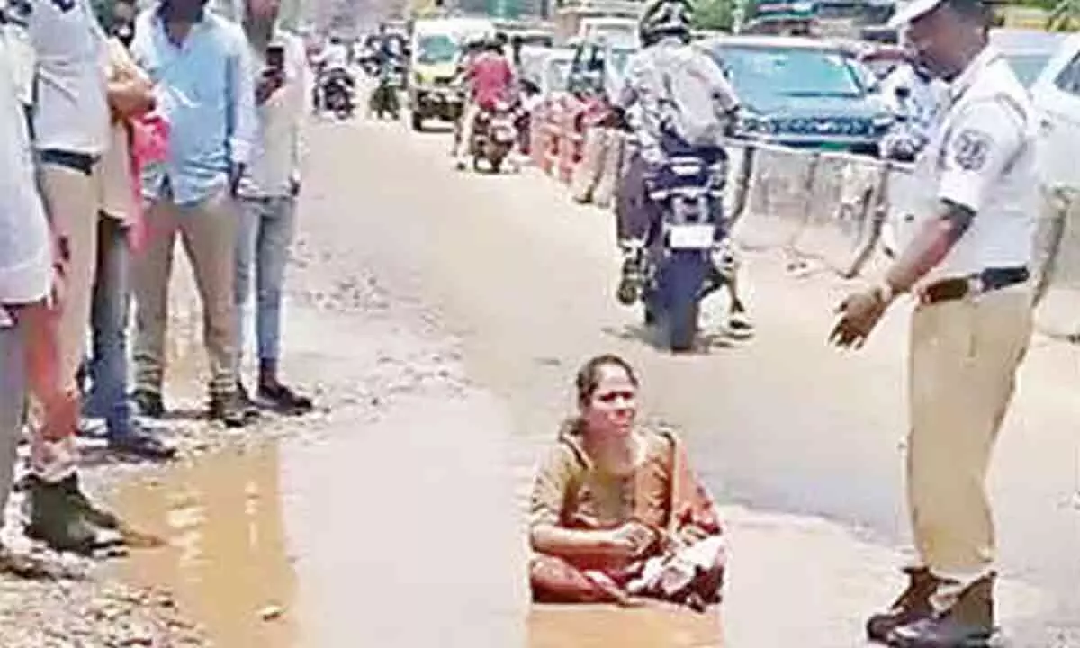 Protestor in Nagole Sits on Pothole to Demand Better Roads