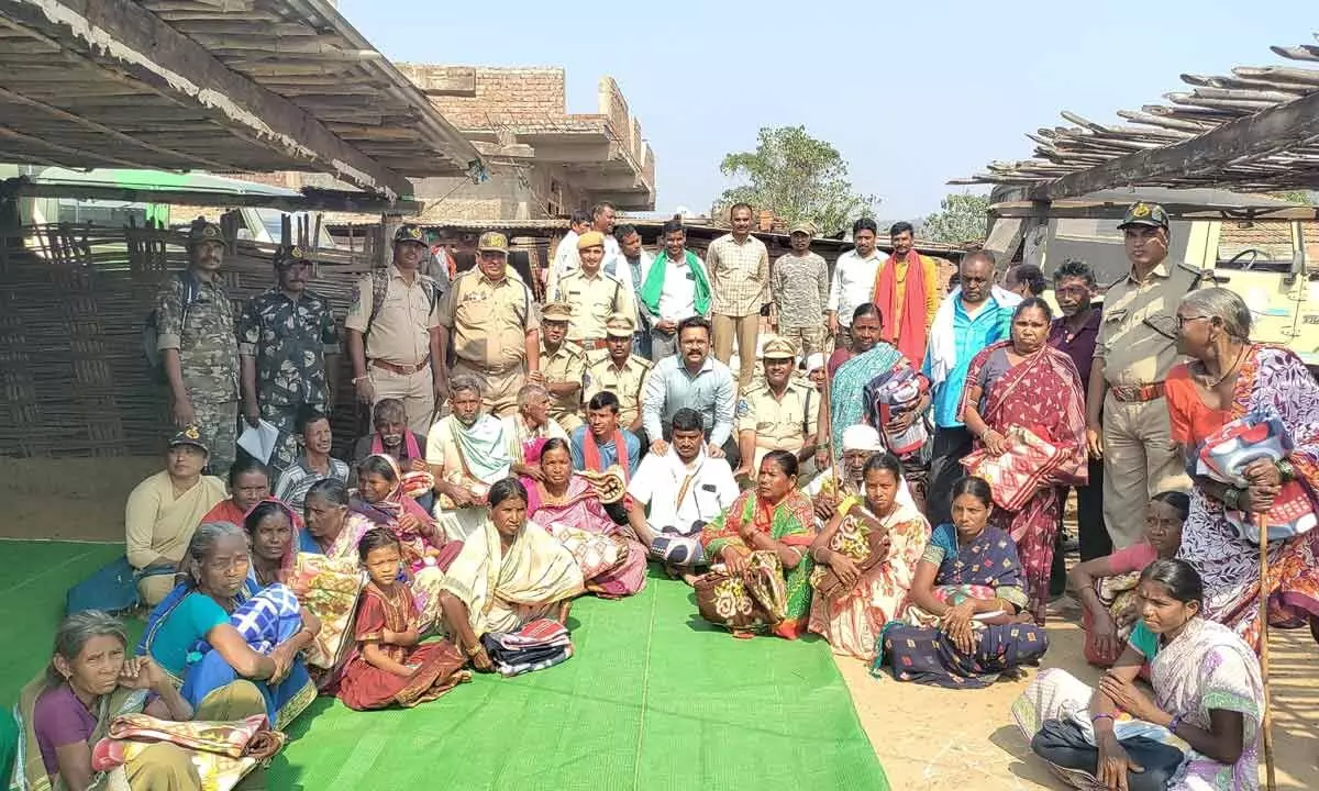 Forest officer hands out blankets to tribal families